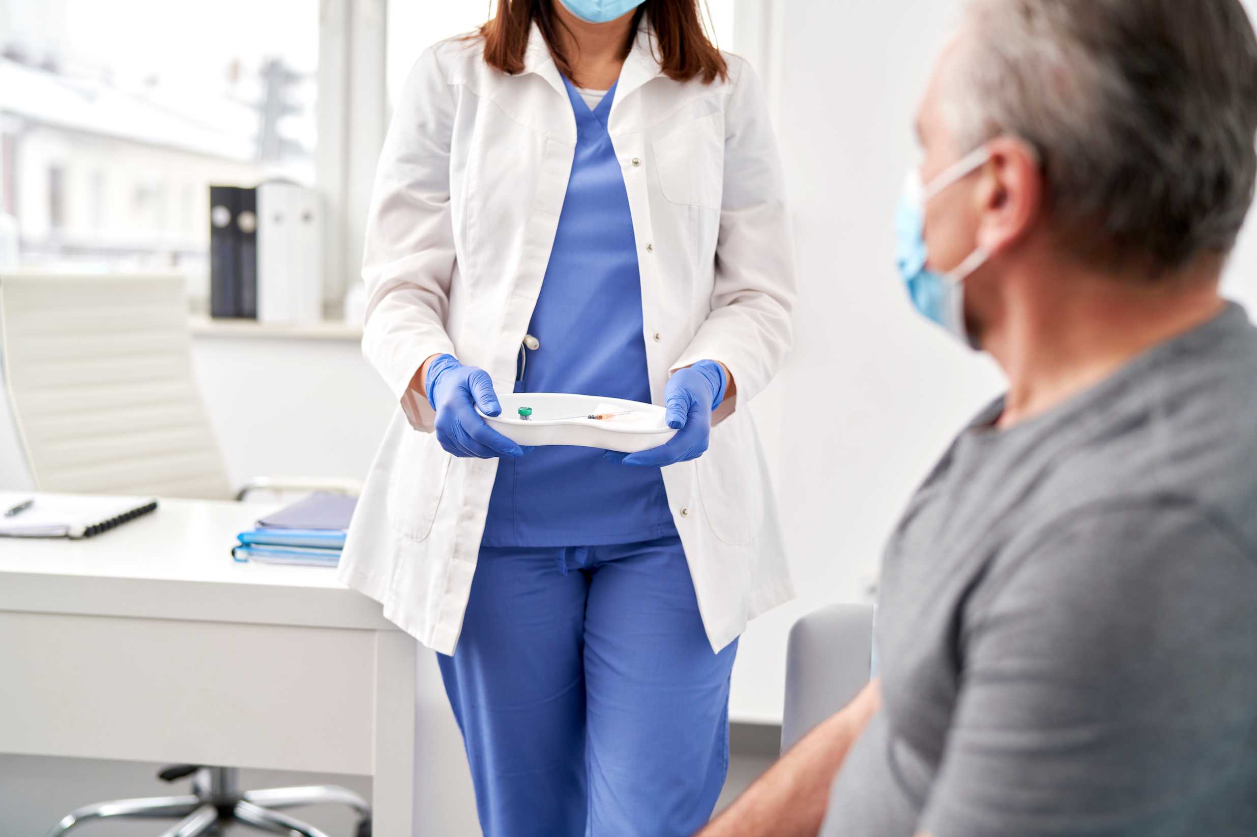 Nurse offering to help patient with injection